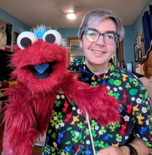 me holding a red hand puppet